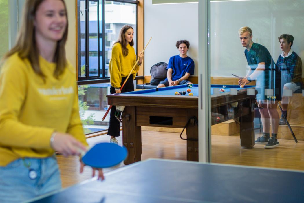 Students socialise at the pool and table tennis tables at Rochester and Rutherford Hall