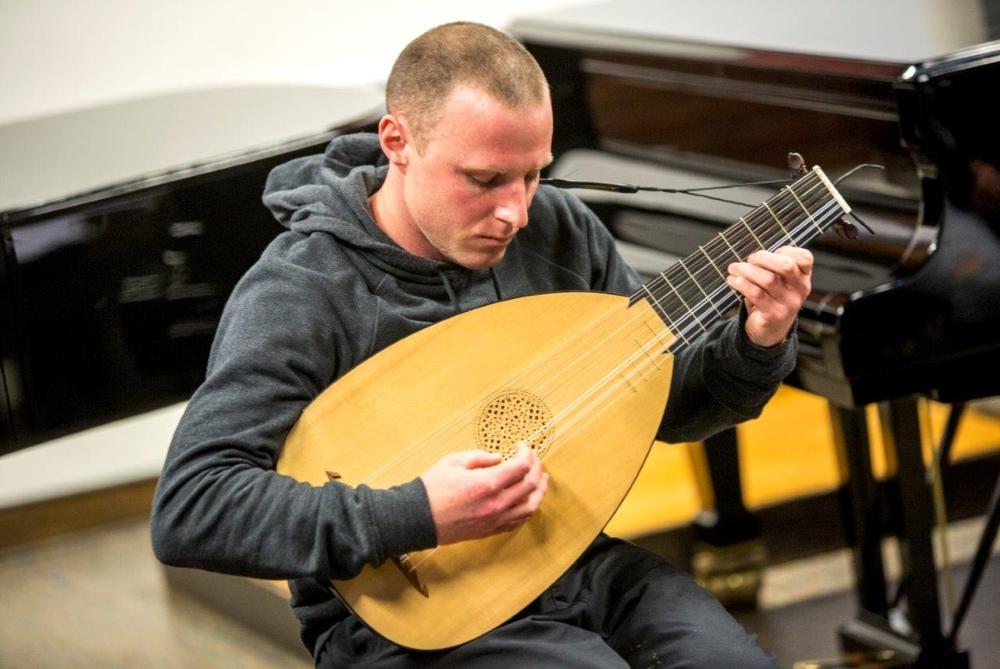 Music student playing the lute