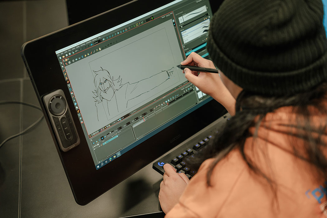 Game Arts student working on a drawing in UC's Digital Production Lab.